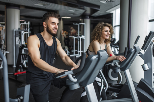 man and woman taking part of spinning class