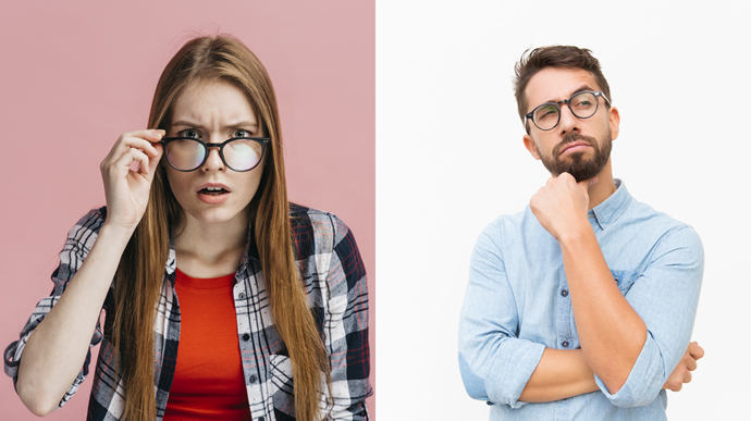 Woman looks intently lowering her glasses on her nose