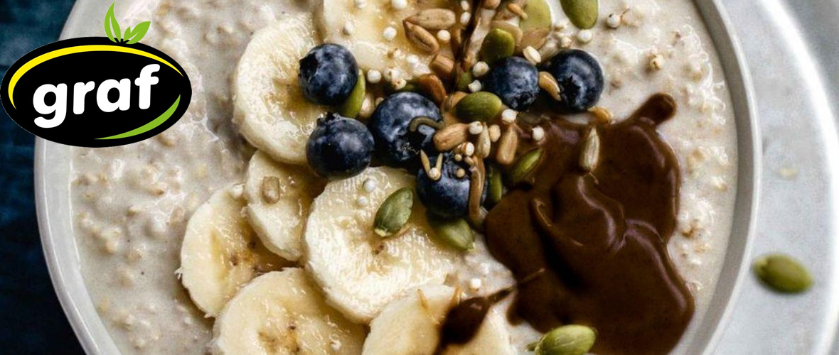 oat meal with carob cream graf, slices of banana, blueberry and pumpkin seeds